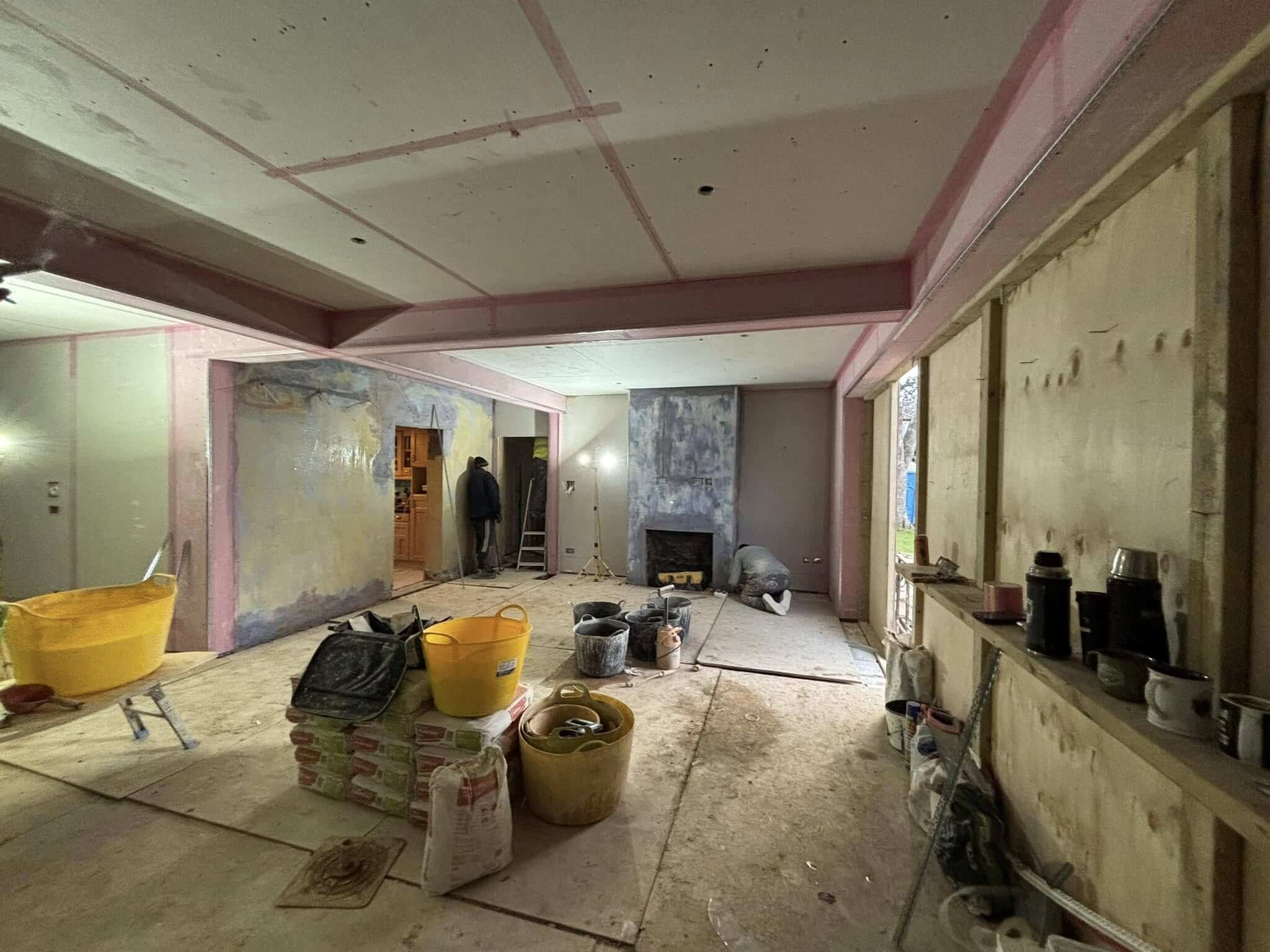 Renovated bedroom with French doors, soft curtains and a vertical column radiator