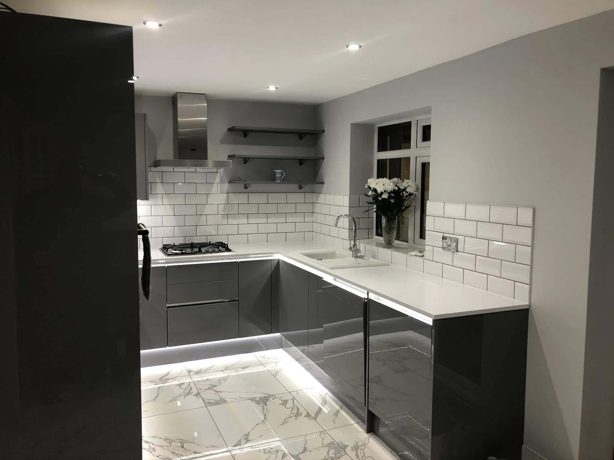 Finished kitchen with grey gloss units, white subway tile splashback and marble floor