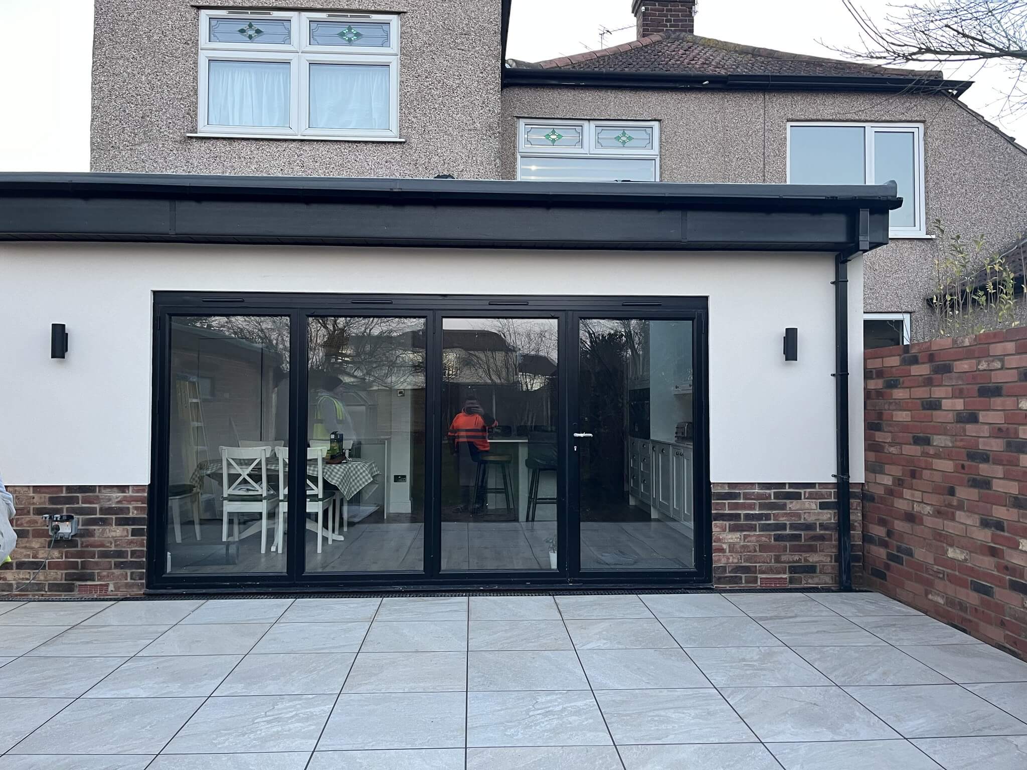 Single-storey rear extension with anthracite bifold doors and porcelain paving on a Bromley family home